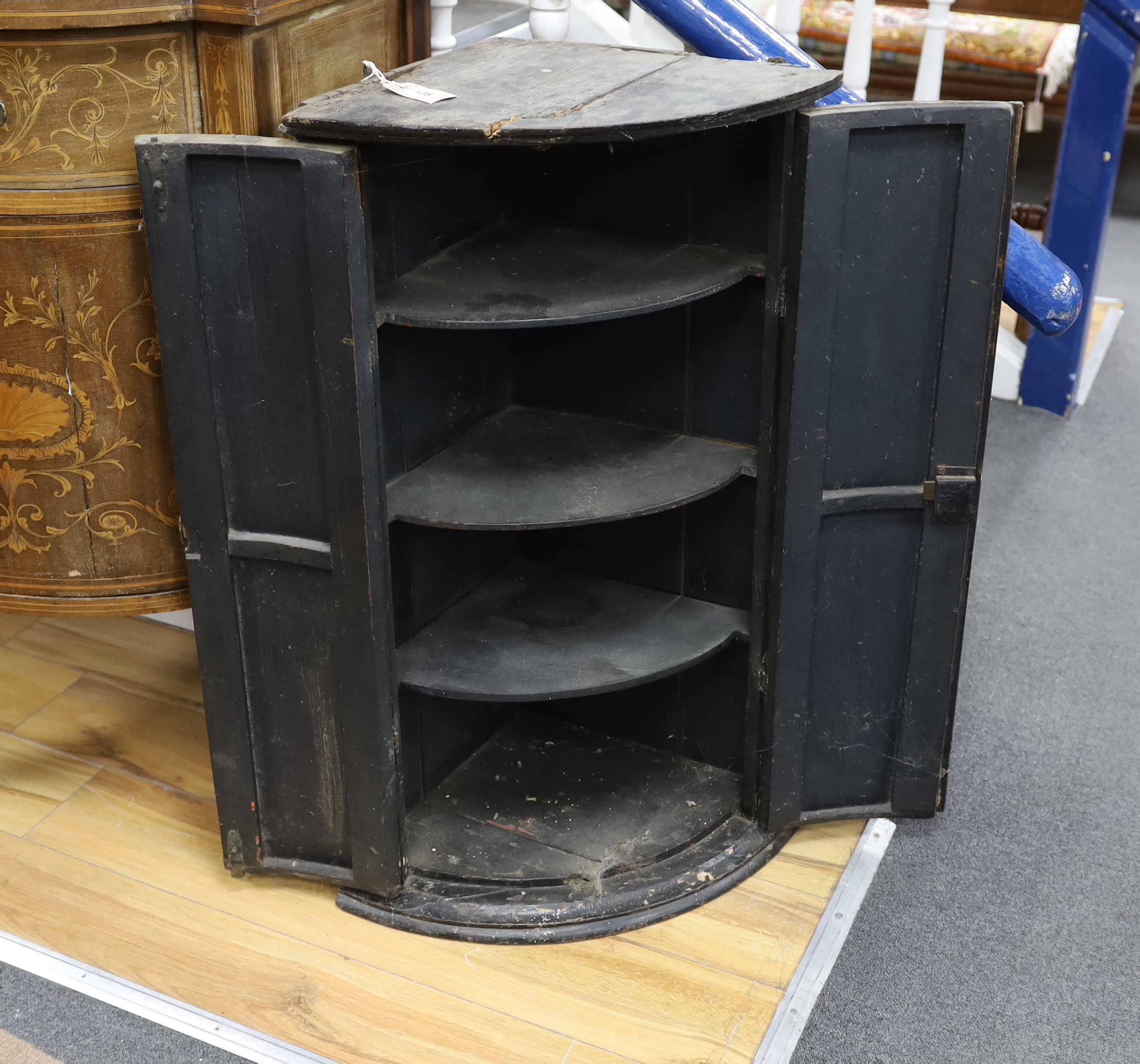 An 18th century painted bowfront hanging corner cupboard, width 56cm, depth 39cm, height 90cm